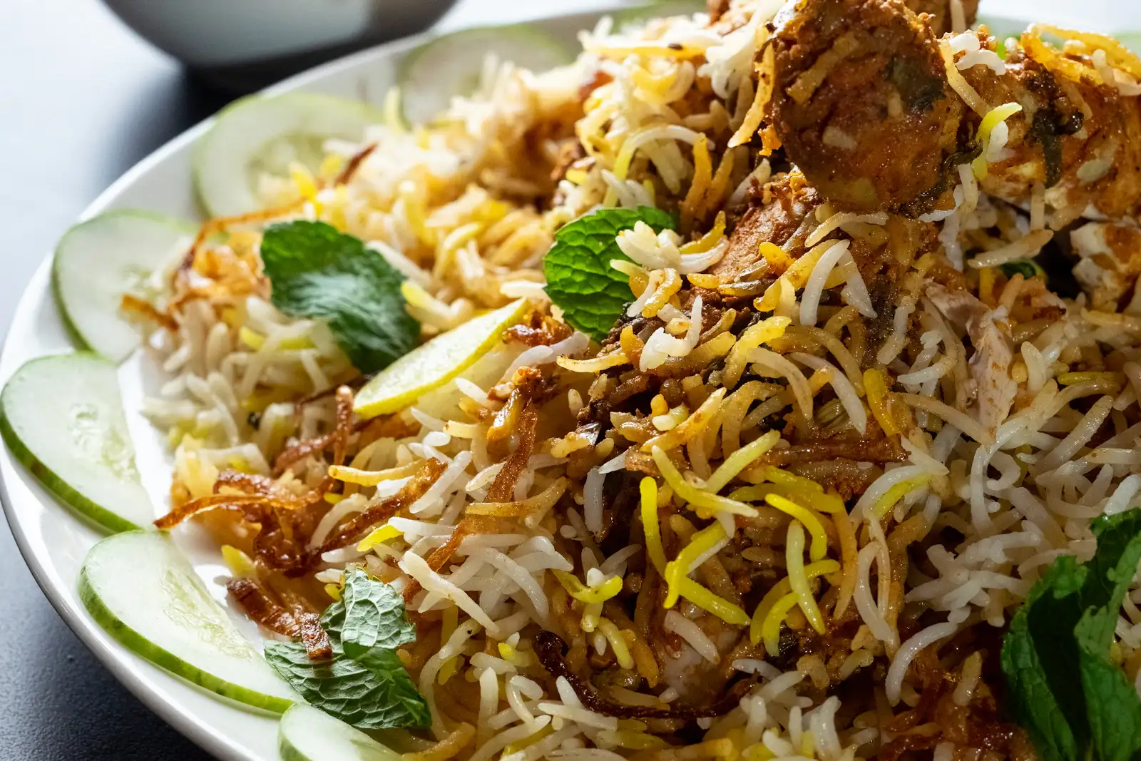 Biryani rice with chicken on a white plate — illustrative food photograph